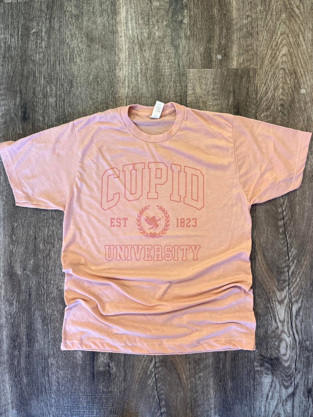 Cupid University Pink Print On Heather Peach Tee